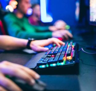 Professional cyber video gamer studio room with personal computer armchair, keyboard for stream in neon color blur background. Soft focus (Professional cyber video gamer studio room with personal computer armchair, keyboard for stream in neon color bl