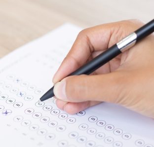 Closeup of Person Filling out Questionary Form